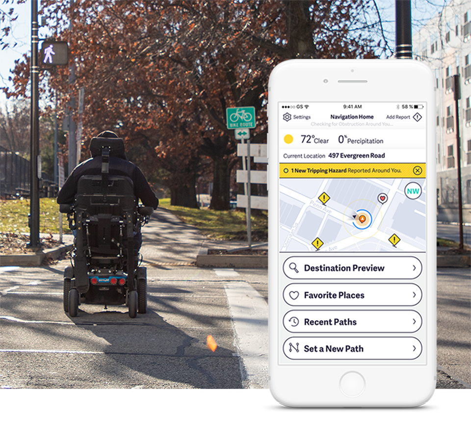 a pedestrian using a power wheelchair crosses an intersection in Pittsburgh. A simulated pathVu mobile app screen shows hazards along the route