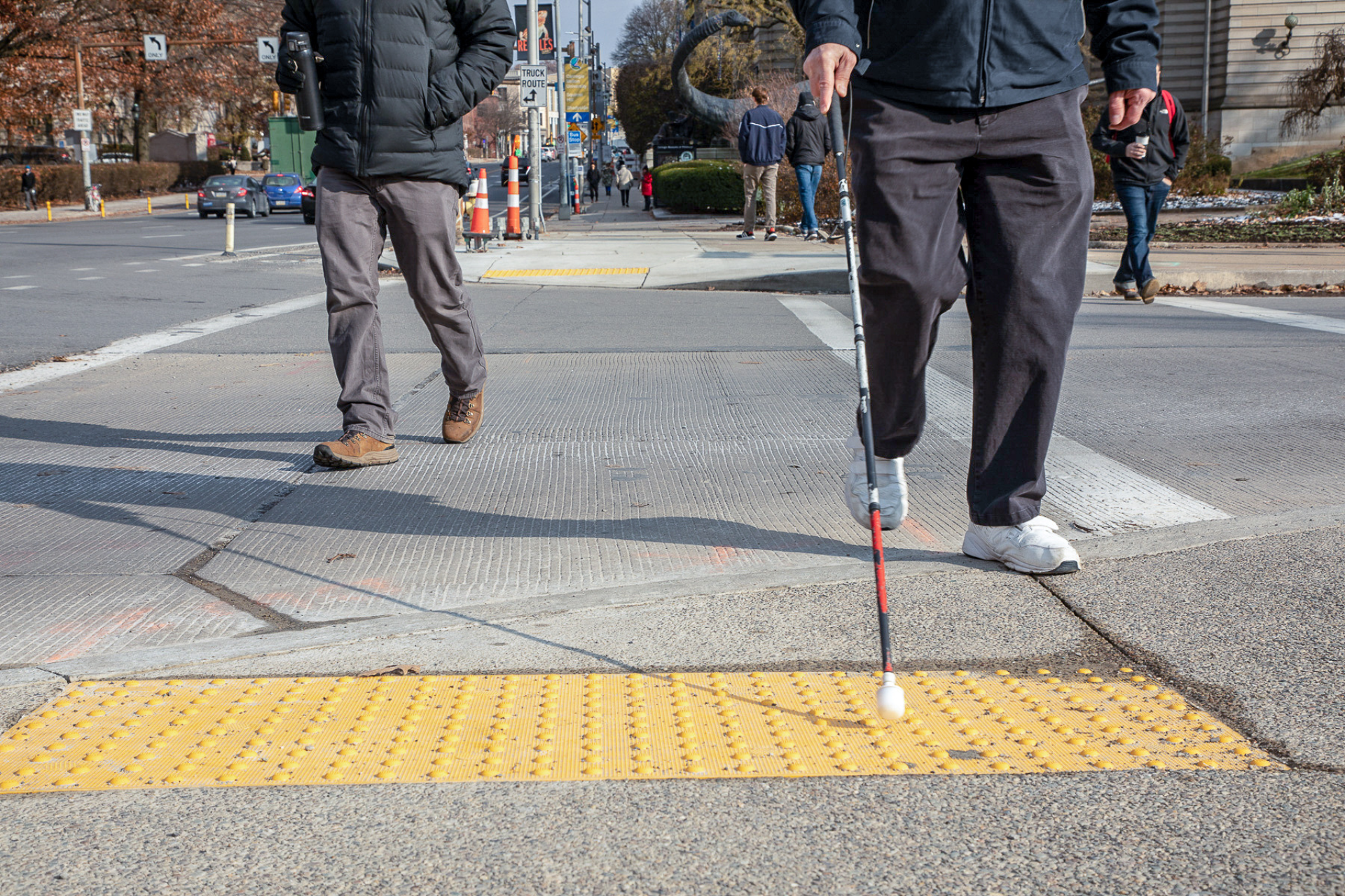 Image of a blind person crossing the street